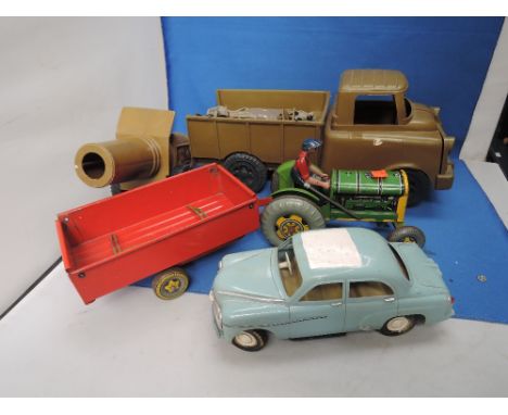 A Mettoy tin plate tractor with driver and trailer with hay gates, a Victory Industries plastic battery operated saloon car a