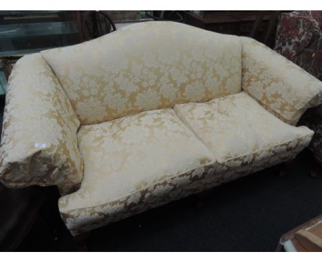 A modern sofa in the classical style having ball and claw feet and gold upholstery