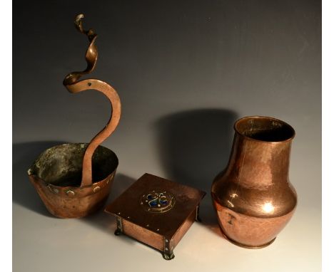 An Arts and Crafts copper hammered trinket box, the cover embossed with Fleur De Lys in blue and green enamel, riveted feet, 