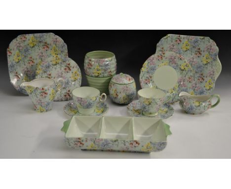 A Shelley Melody pattern novelty floral chintz preserve pot and cover, modelled as a fruit, typically printed with summer flo