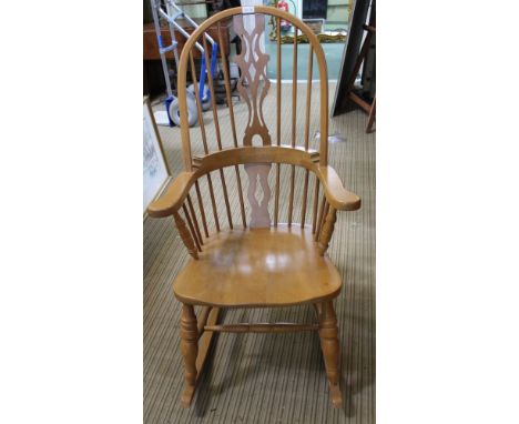 A MODERN BEECHWOOD DOUBLE COMB BACKED ROCKING ARMCHAIR 