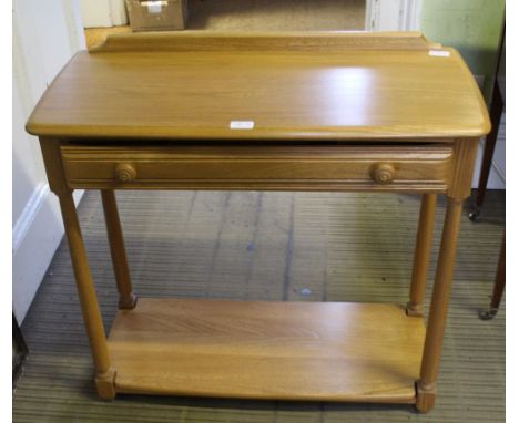 AN ERCOL SIDE TABLE fitted with a single full width drawer, supported on plain turned legs, with a solid undertier 