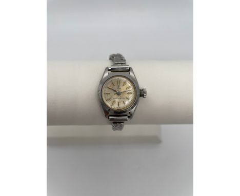 A TUDOR OYSTER LADIES STAINLESS STEEL WRIST WATCH with manual wind movement, silver dial, gold baton numerals and silver hand