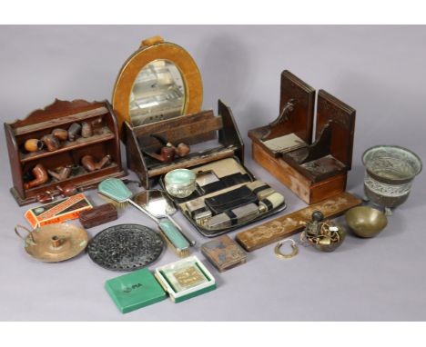 A pipe-rack, various pipes, an adjustable book trough, a small oval wall mirror, etc.