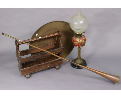 A brass oil table lamp with floral painted glass reservoir and with an etched glass globular shade, together with a brass eng