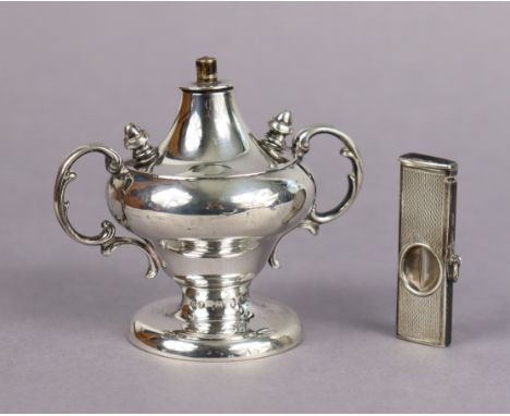 A late Victorian silver cigar lighter in the mid-18th century style, of inverted pear shape with scroll handles, two removabl