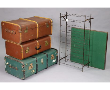 A wrought-metal wine-rack, 19½” wide x 40” high; together with two fibre-covered travelling trunks; &amp; a card table. 