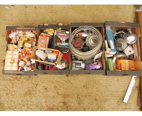 Four boxes of mostly new old stock car parts including bulbs, lamp parts etc.