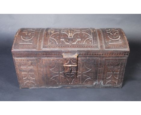 A leather covered, domed top trunk with tooled geometric decoration, height 41cm, width 80cm, depth 36cm. 