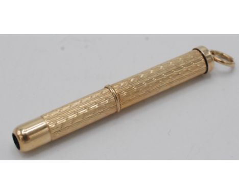 A 9ct gold engine turned propelling tooth pick.