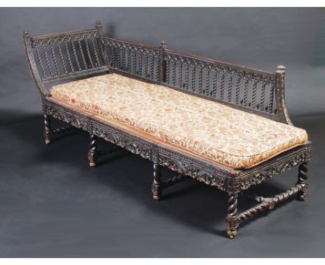 An ebonised ornate carved chaise longue in eastern style, with spiral pillars.   Condition report:  This is a little worn, th