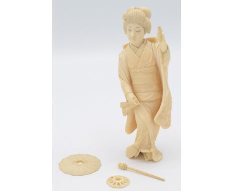 A Japanese ivory okimono, a geisha holding a fan in one hand, height 13cm.    Condition report:  Condition Report: The paraso