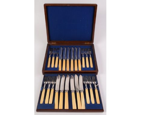 A set of twelve EPNS engraved fish knives and forks with ivory handles in a burr walnut canteen.