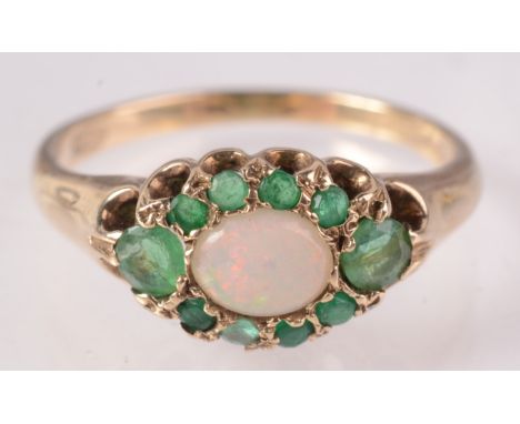 A 9ct gold opal and emerald oval cluster ring. 