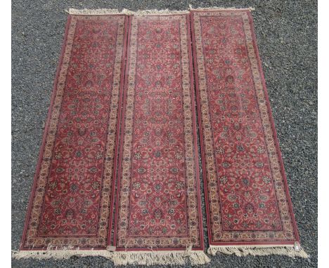 Three matching machine made runners, each bearing the label 'Royal Keshan', the pink field with an all over design of palmett