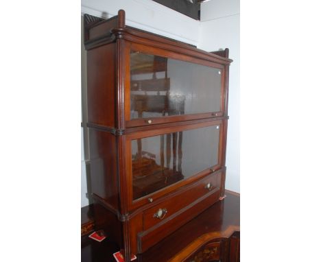 A good sectional walnut Wernke bookcase in two sections, a lower drawer with a carved gallery and mother of pearl inlaid silv