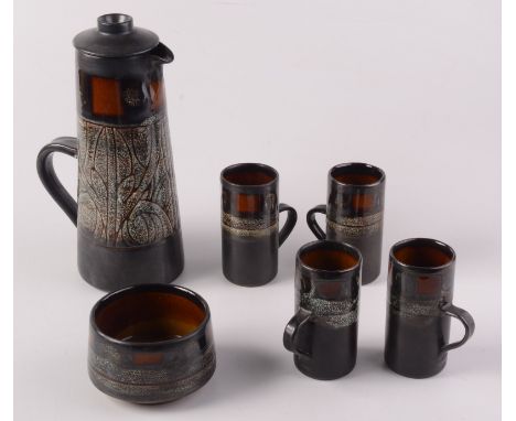 A Celtic Pottery, Newlyn 'Medallion' pattern coffee set, comprising a coffee pot, four coffee cans and a sugar bowl.  