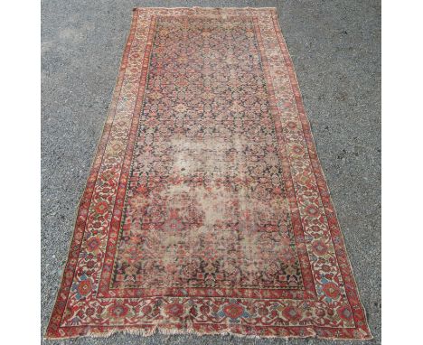 A Feraghan Kelleh carpet, the black and indigo abrash field with the all over Herati pattern, within an ivory arabesque borde