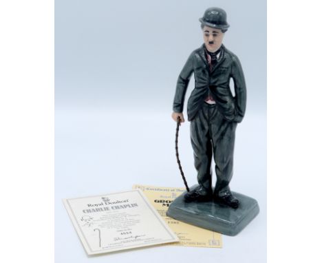 A Royal Doulton porcelain figure of Charlie Chaplin, HN 2771, with certificate. Modelled by William K. Harper, this is issued