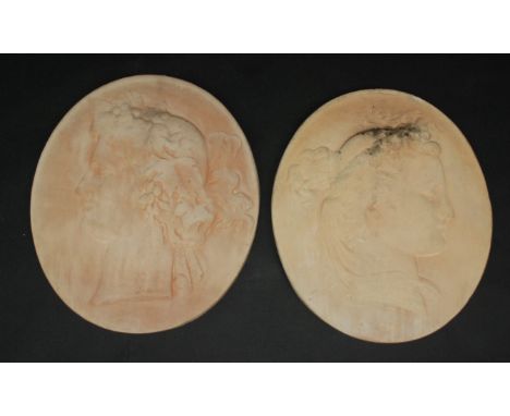 A pair of oval plaster plaques, each decorated with a portrait of a lady, 41.5 x 36cm.
