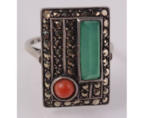 A stylish European Art Deco ring set red coral, marcasite and 'jade'.