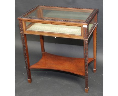 A good late Victorian mahogany display table with blind fret carving to the lid and legs, concave low open shelf, 68cm.    Co