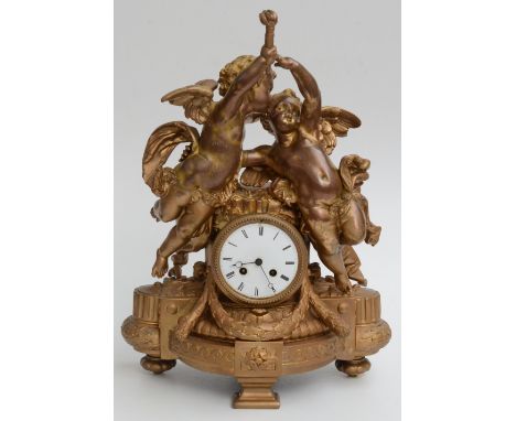 A gilt metal mantel clock, 19th century, with a pair of winged cherubs above a 10cm enamel dial, height 51cm, width 36cm. 
