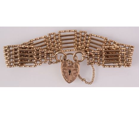 A six bar gate link bracelet in 9ct gold with padlock clasp, 26.4g. 