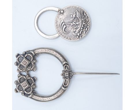 A silver talisman padlock and a silver Celtic Tara brooch. 