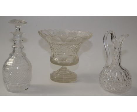 A large cut glass footed bowl, height 23.5cm and a cut glass decanter and ewer.    Condition report:  Chips to top of bowlSto