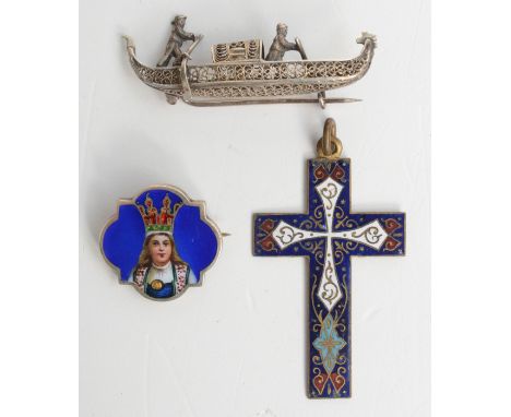 An enamelled silver brooch showing a portrait of a girl in national dress, together with an enamelled cross and a filigree go