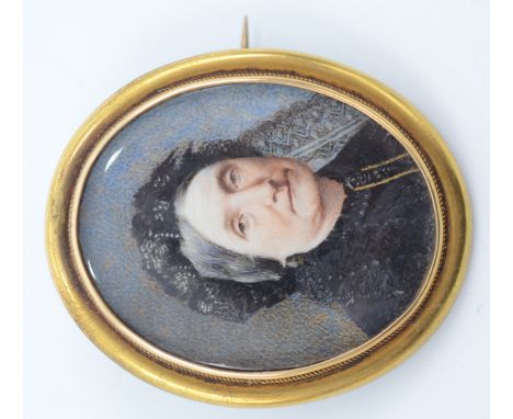 A Victorian brooch set a portrait miniature of an elderly lady, the back with a lock of hair. 