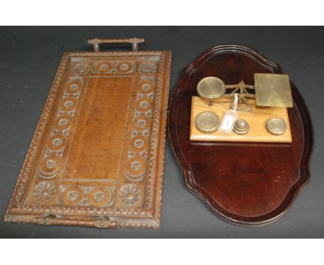 A set of post office scales with brass weights, together with two trays.