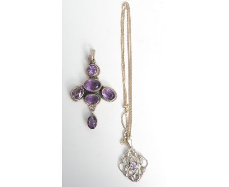 An Arts and Crafts style silver pendant set amethyst and one other amethyst and silver pendant.