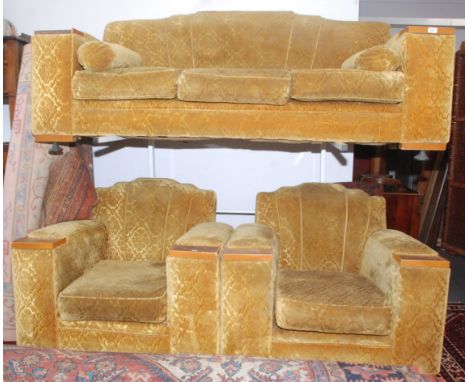 An early 20th century three seat sofa, upholstered in floral cut gold moquette, together with a pair of matching armchairs.  