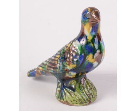 A  Chinese san sai mottle enamelled biscuit ware porcelain figure of a bird upon a rocky base, Kangxi style. 19th century. Wi