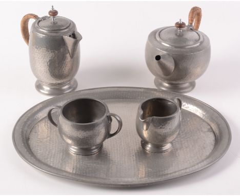 A Liberty & Co 'Tudric' pewter tea service, circa 1920, comprising teapot, hot water jug, cream and sugar, on an associated t