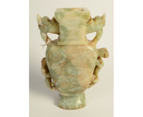A Chinese mottled green and brown jade, two handled vase of flattened baluster form, the body engraved in low relief with a s