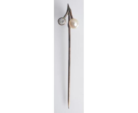 A diamond and pearl pin, cased.