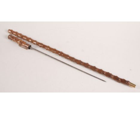 A steel sword stick, in a wooden scabbard, total length 91cm.   Condition report:  Handle has a compartment for a miniature f