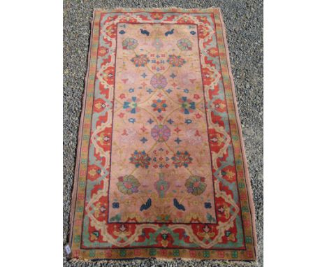 A Tabriz rug, the coral field decorated with vases of flowers, vines and palmettes within a madder meandering vine border, 17