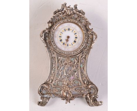 An ornate miniature French clock in Louis XV style, the case in silver and mother of pearl.    Condition report:  Full height