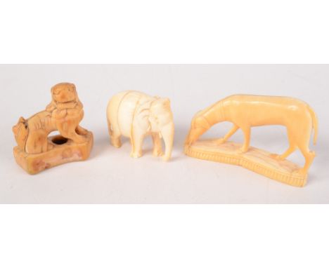 An ivory figure of a dog, length 6cm, an elephant and a mythical creature. 
