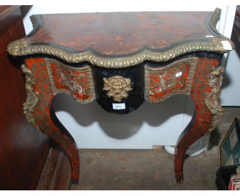 A 19th century French Buhl red ground and ebonised console writing table, 77cm.