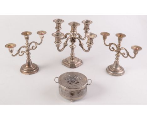 A four branch candelabrum, together with a pair of three nozzle candelabra and one other piece.