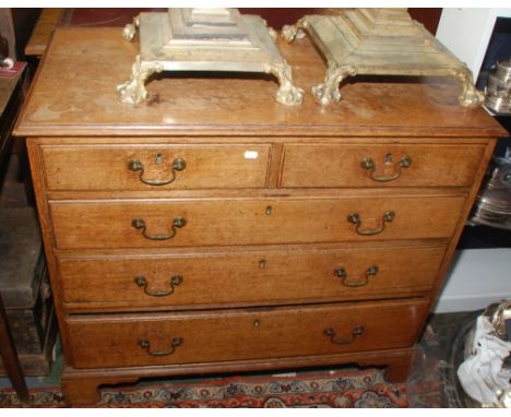 A George III light oak chest of small proportions fitted two short and three long graduated drawers on bracket feet, original