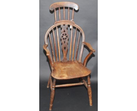 An unusual 19th century wheel and stick back armchair with extended stick head rest.   Condition report:  Condition good but 