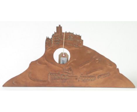 A copper mantle clock frame depicting St Michael's Mount with a hinged stand, height 22.5cm, width 47cm. 