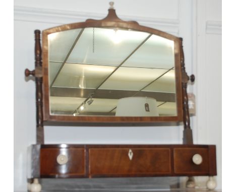 A George III mahogany toilet mirror, the arched glass with ivory finial, the bow front base fitted three drawers with ivory k