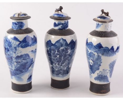 Three Chinese blue and white crackle glaze vases, circa 1900, each with riverside scenes and four character Kangxi mark to ba